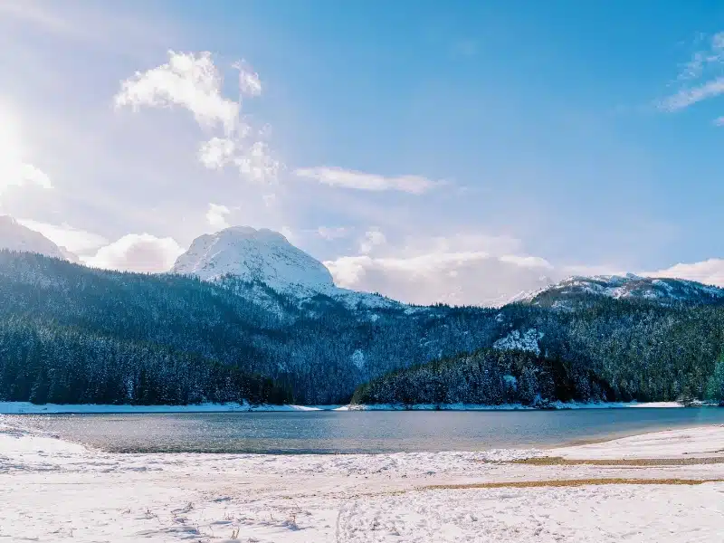 Lake surrounded by snow capped mountains