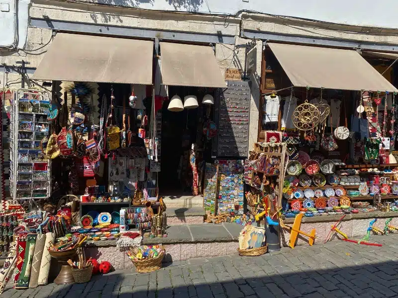 colorful shop on a cobbled street selling Albanian souvenirs and toys