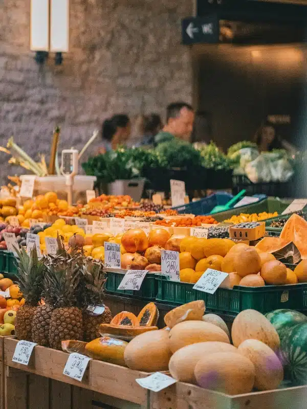 seasonal and fresh fruit and vegetables displayed in a market