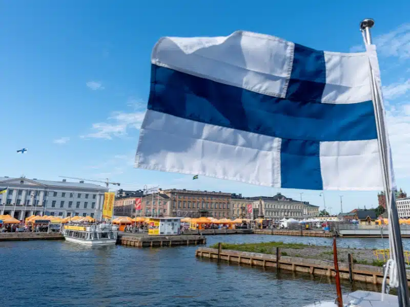 Helsinki Harbor at Market Square with Finnish Flag in Foreground