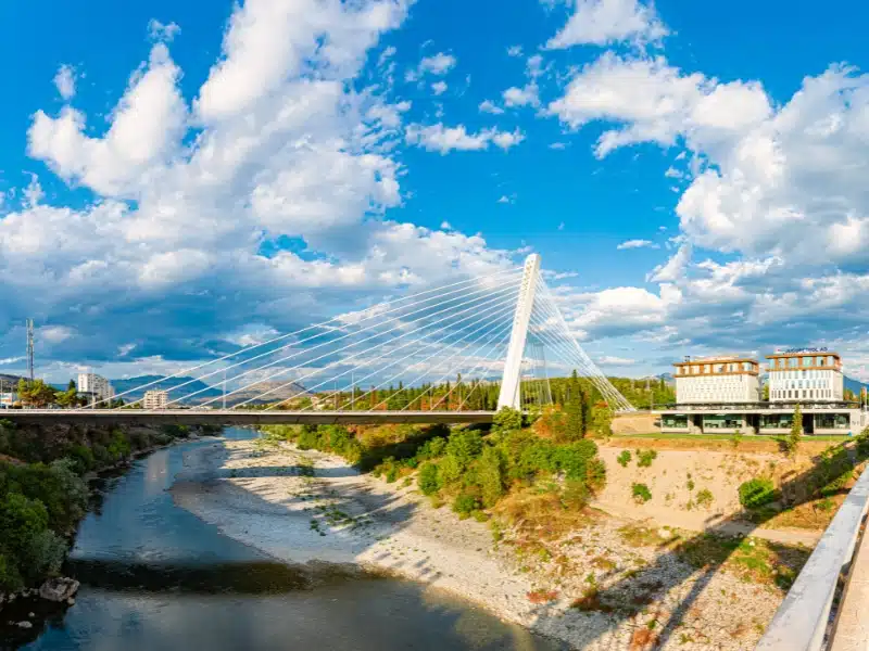 Sunny day with blue sky and white clouds. Modern bridge in Podgorica city, Montenegro, Europe