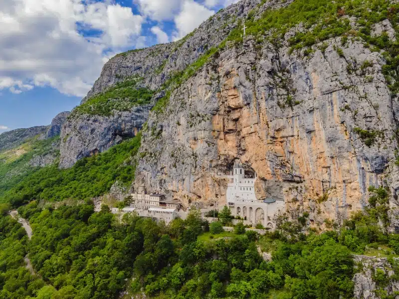 Monastery of Ostrog, Serbian Orthodox Church situated against a vertical background, high up in the large rock of Ostroska Greda, Montenegro. 