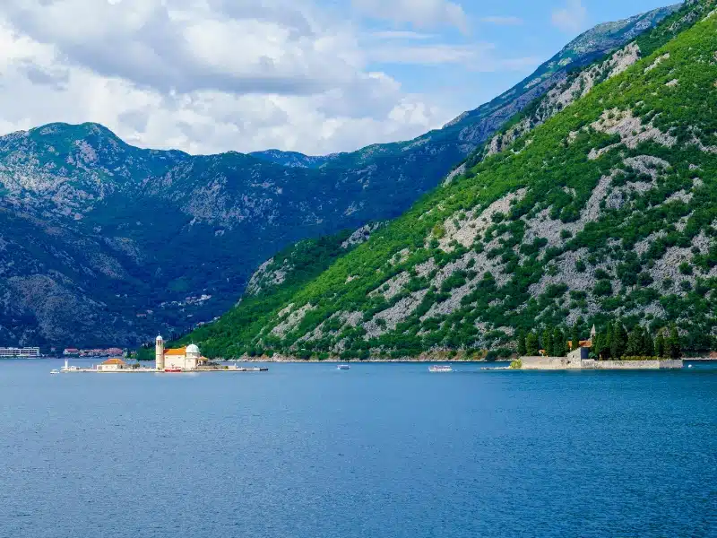 small islands in a large bay with steep mountains to the water