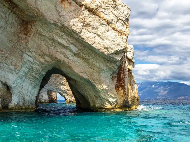 Series of rocky arches surrouned by blue and green sea