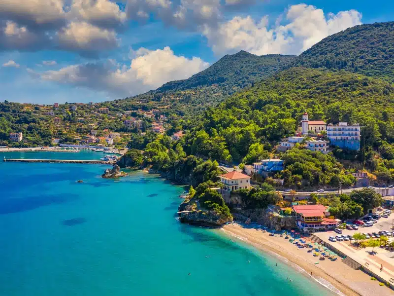 Aerial view of city of Poros, Kefalonia surrouned by lush forest against a blue sea