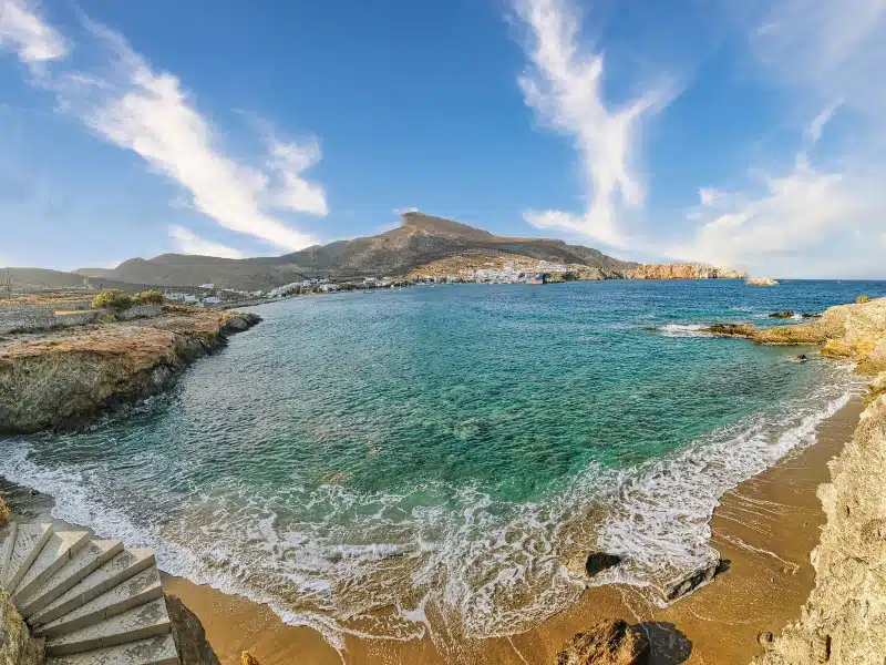 Latinaki Beach with stone steps, rocky shoreline and turquoise sea