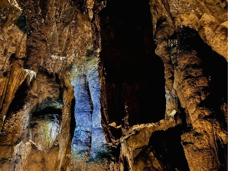 illuminated rock columns in an underground cave