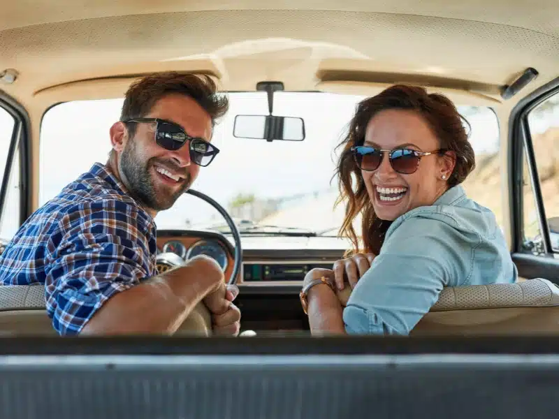 couple and driving in car for vacation