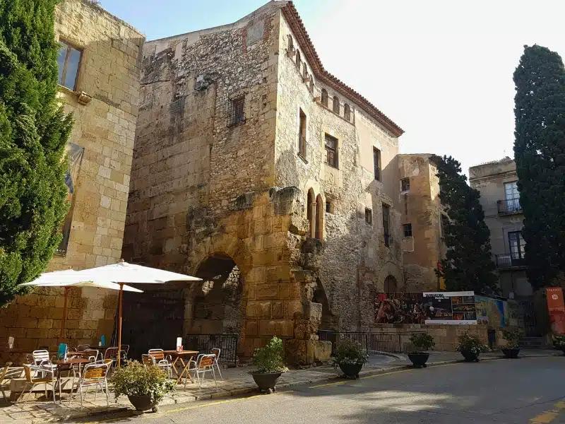 Honeyed stone buildings with outside tables and chairs