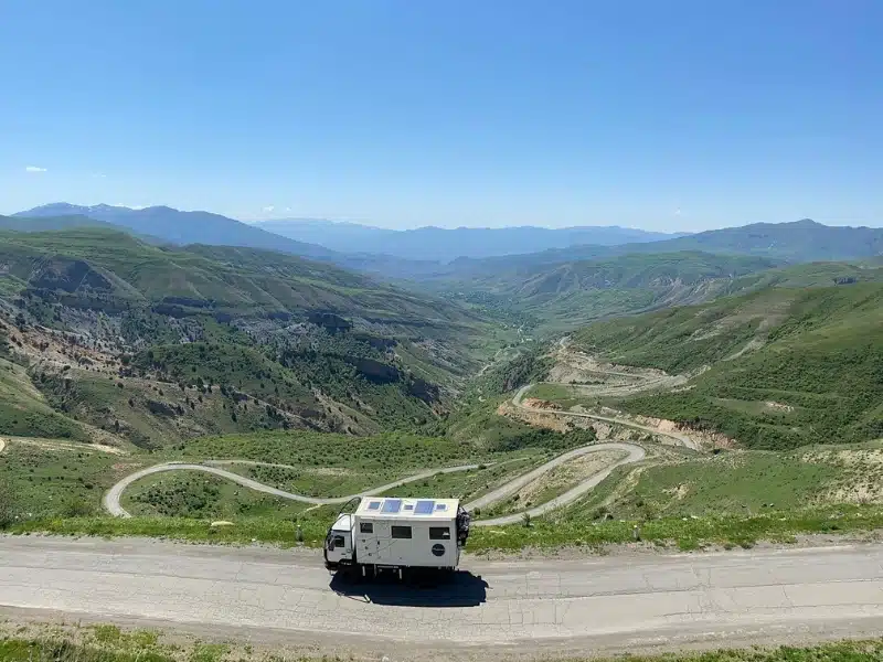 truck on a twisting road through mountains in Armenia