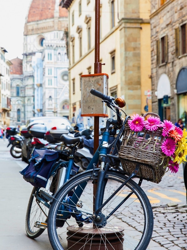 Bicycle decorated with flowers parked at Via de Cerretani in Florence