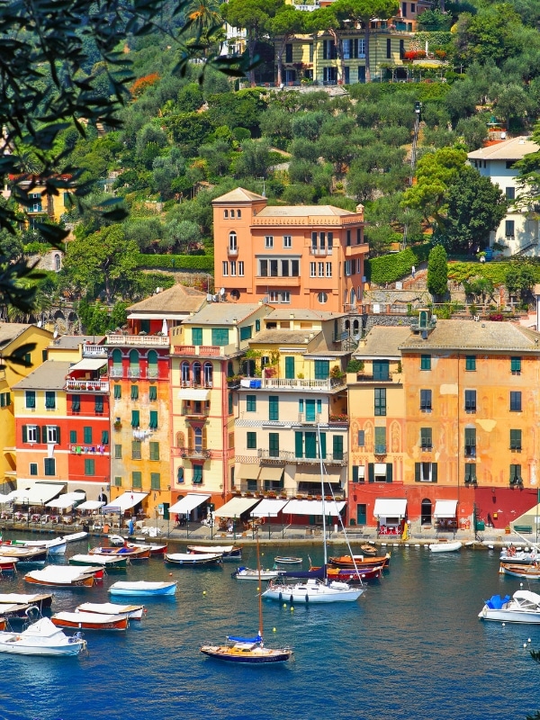 Vertical oriented image of Portofino and bay with yachts and boats on Ligurian sea, Italy.