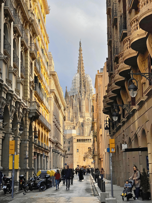 wet street in Barcelona with the Sagrada Familia at the end