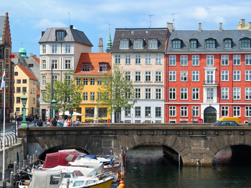 colorful canalside buildings over an arched bridge