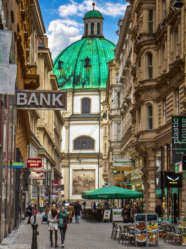 City street with huge green domed building at the end