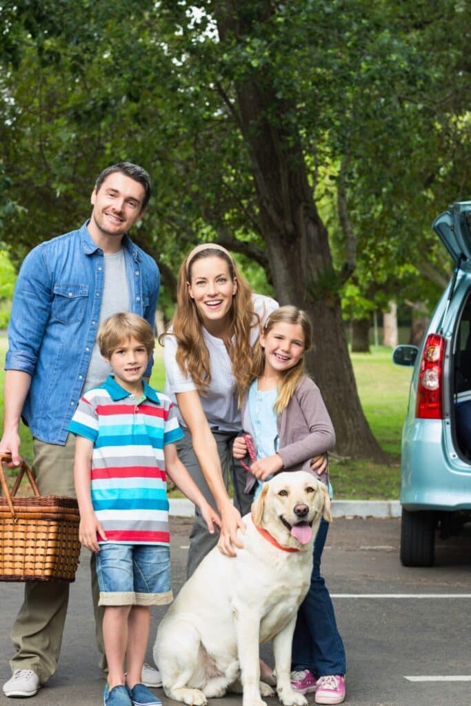 Family enjoying a road trip with kids, snacks, games, and organized packing