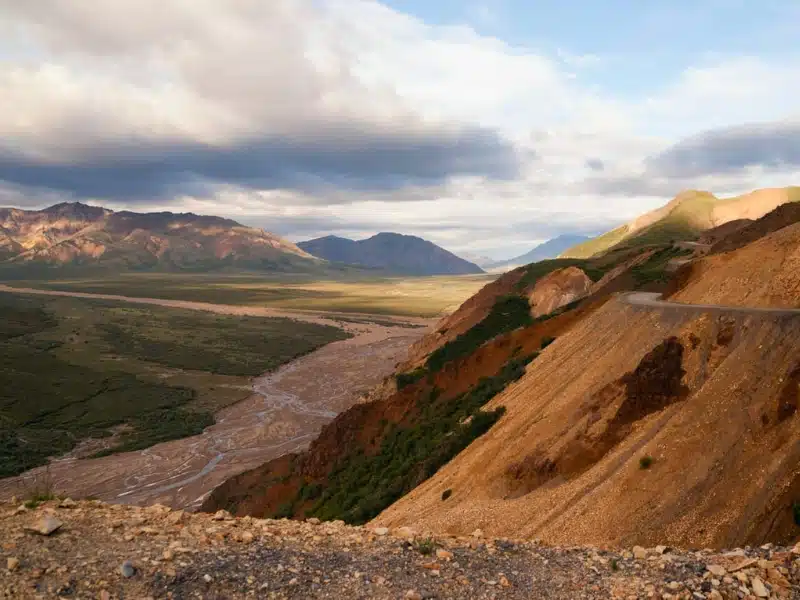 Peaks Sky Valley's Park Road Denali National Park with a road cutting through Denali late in the summer