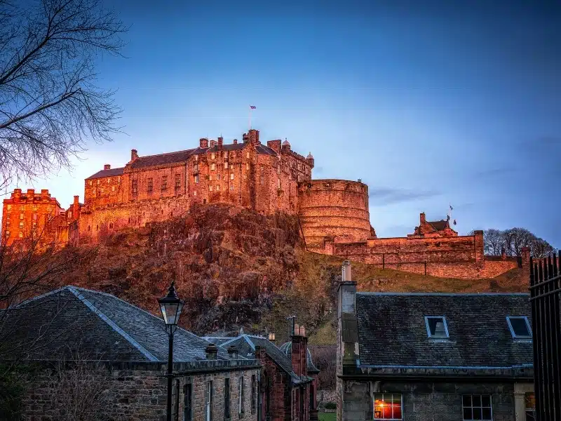 medieval castle atop a hill at golden hour