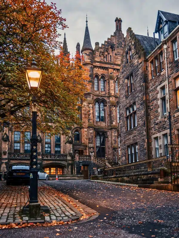 Glasgow, the UK, Lit Lamp and Historic Buildings at Glasgow University