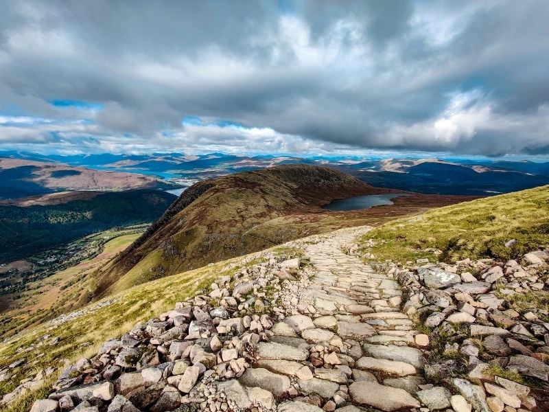 rocky path over a mountain with stunning views of lochs and more mountains