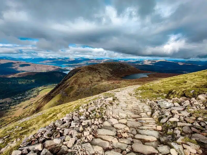 rocky path over a mountain with stunning views of lochs and more mountains