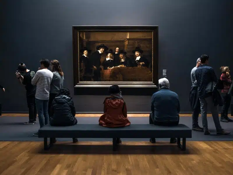 Group of people looking at a painting by Rembrandt
