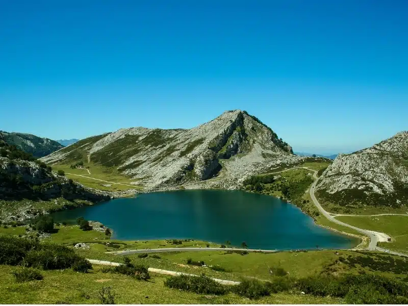 Road traverses a lake high in the mountains of Northern Spain