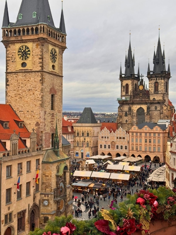 Traditional European architecture around a central square hosting a Christmas market
