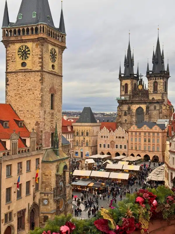Traditional European architecture around a central square hosting a Christmas market
