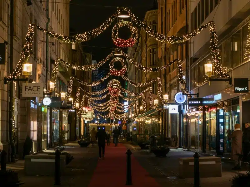 Shopping street in the evening with Christmas decorations hanging over the street