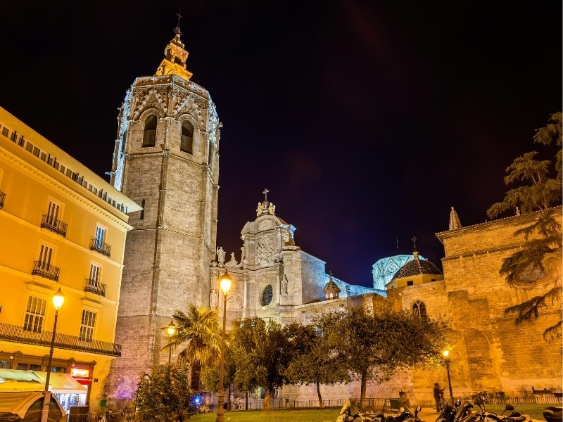 Historic cathedral and other uildings on a main square at night