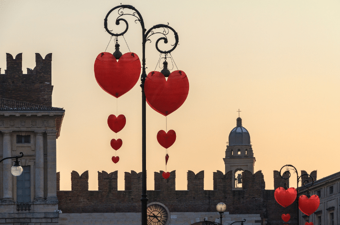 Heart shaped decorations adorn metal lamp posts in verona