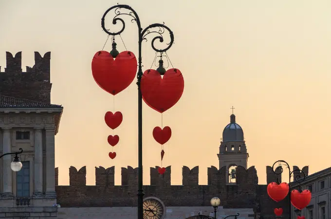 Heart shaped decorations adorn metal lamp posts in verona