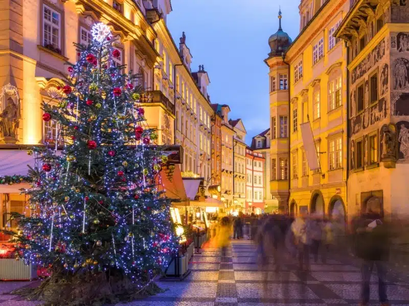 Prague Christmas market on the night in Old Town Square with blurred people on the move