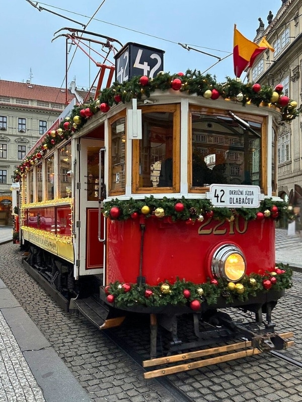 Tradition tram decorated with christmas foliage and baulbale with a number 42 sign
