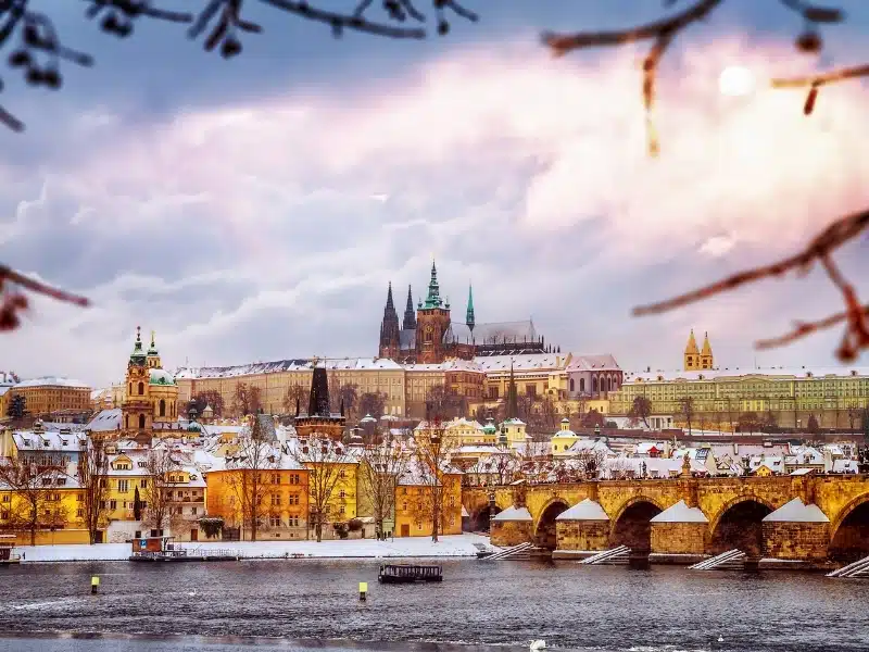 Beautiful Prague in winter, Charles bridge over Vltava river, Czech republic, historical  medieval buildings, wintertime European cityscape