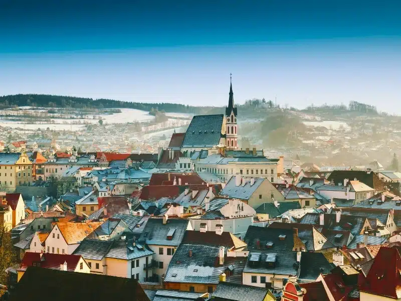 Panoramic view of Cesky Krumlov in winter, Czech Republic. View of the snow-covered red roofs. 
