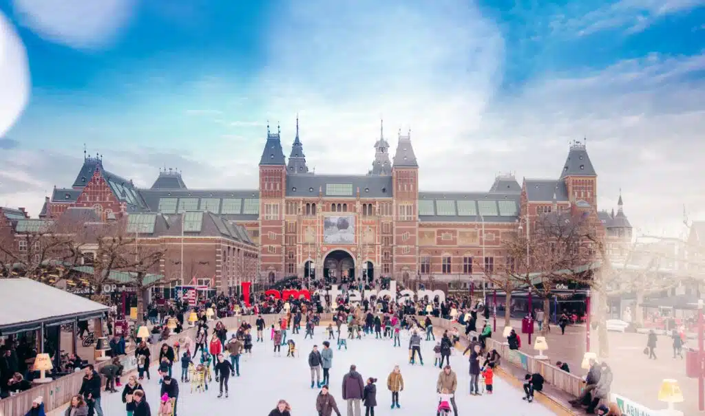 Pleopel ice skating in front of an imposing building