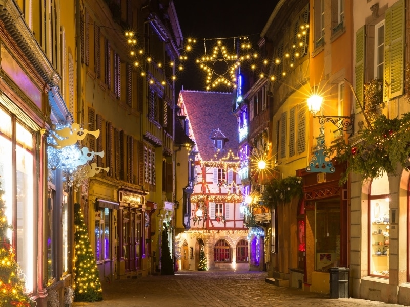 Traditional Alsatian half-timbered houses in old town of Colmar, decorated and illuminated at christmas time, Alsace, France