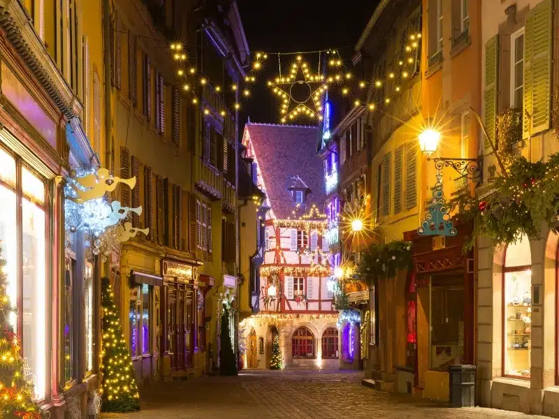 Traditional Alsatian half-timbered houses in old town of Colmar, decorated and illuminated at christmas time, Alsace, France