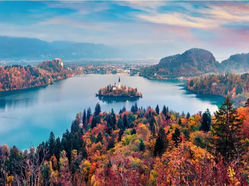 Colorful morning scene of Pilgrimage Church of the Assumption of Maria. Aerial autumn view of Bled lake, Julian Alps, Slovenia, Europe. 