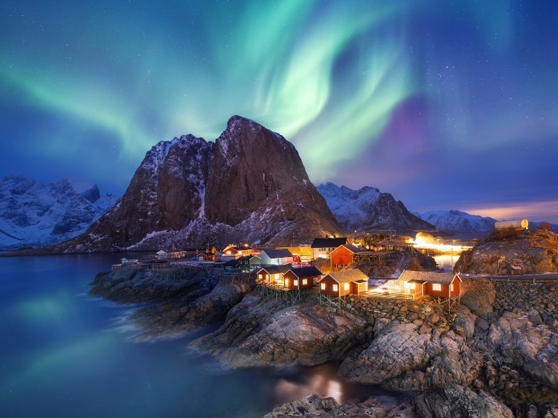 Aurora borealis on the Lofoten islands, Norway. Green northern lights above ocean. Night sky with polar lights.
