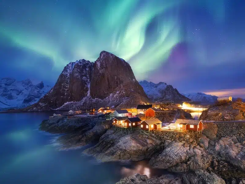 Aurora borealis on the Lofoten islands, Norway. Green northern lights above ocean. Night sky with polar lights. 