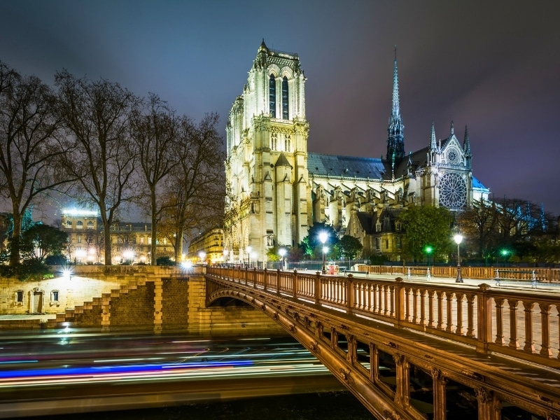 The Cathedrale Notre-Dame de Paris and Pont au Double at night, in Paris, France.