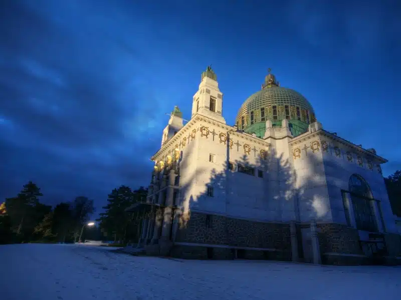 Ornate domed church surrouned by snow at dusk