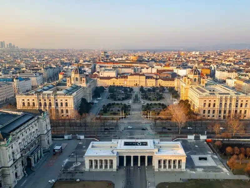 Aerial view capturing Vienna's city center at sunrise, highlighting MuseumsQuartier, Maria-Theresien-Platz, and the Kunsthistorisches and Naturhistorisches Museum