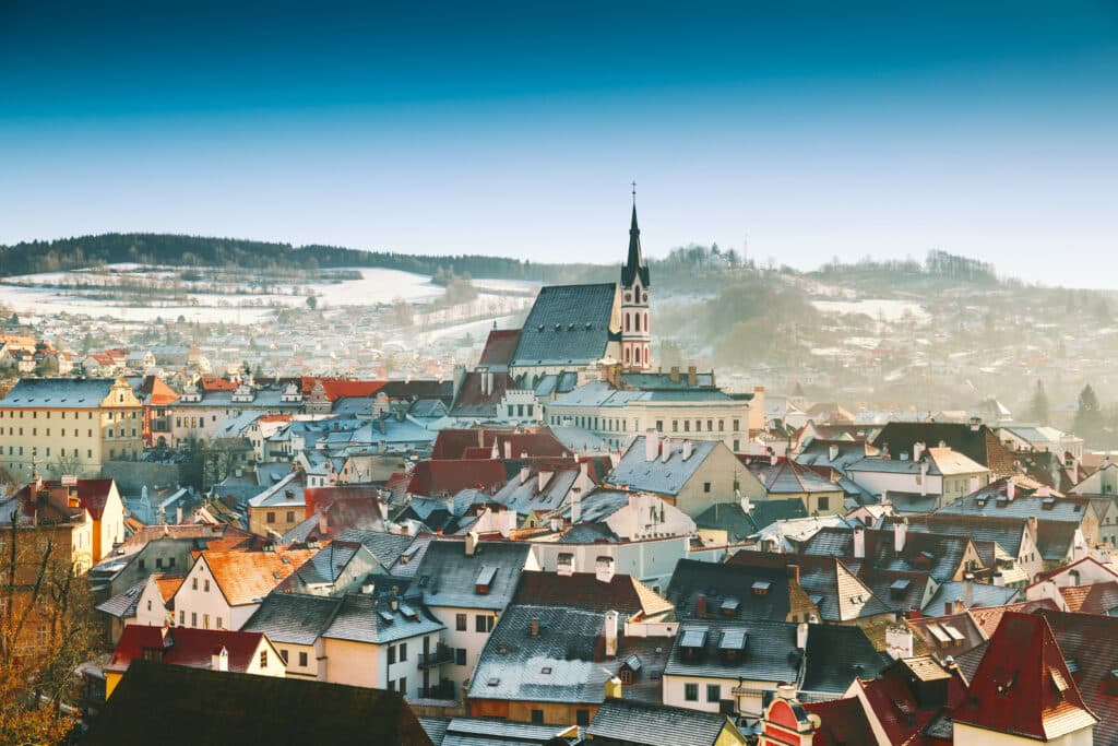 Panoramic view of Cesky Krumlov in winter, Czech Republic. View of the snow-covered red roofs. 