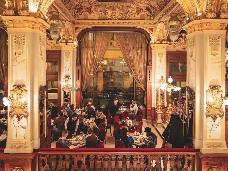 The ornate inside of the historical New York cafe in Budapest