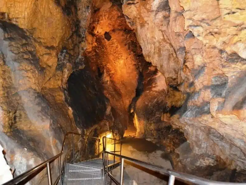 Metal stairs descending into a n underground cave