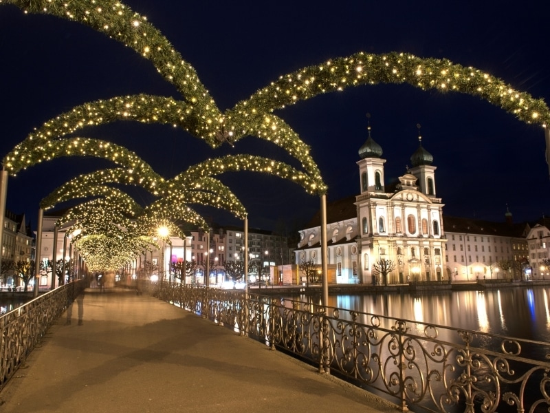 Decorated festive bridge over Lake Lucerne at Christmas